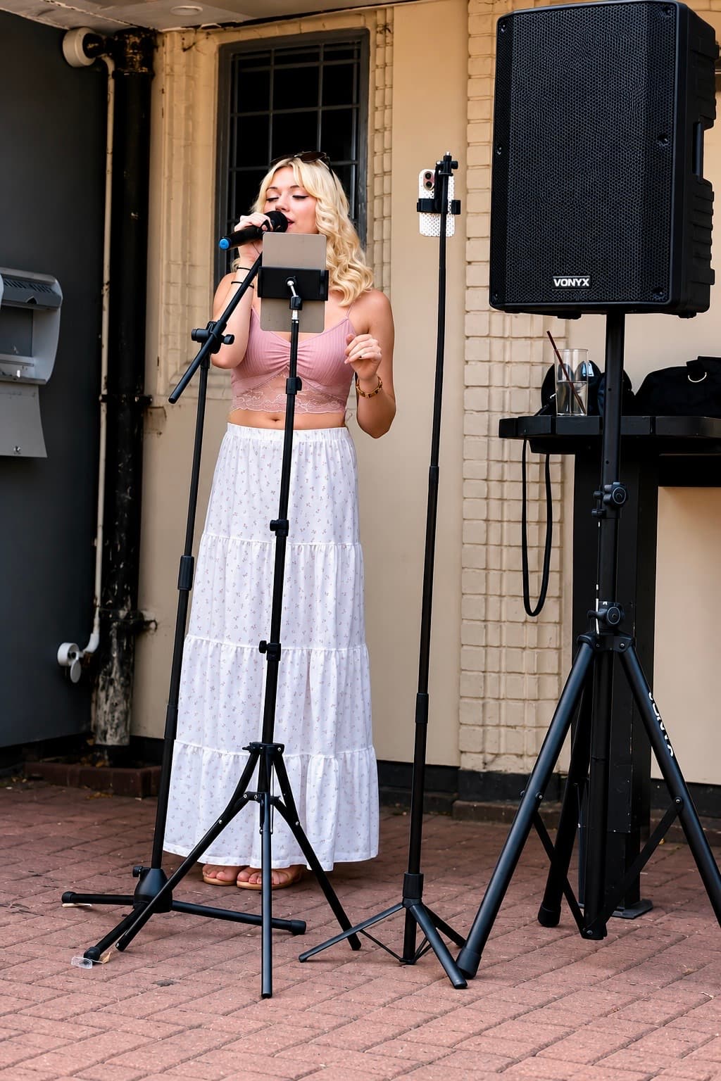 Abz, live singer in Coventry, performing outdoors with microphone stand and PA system